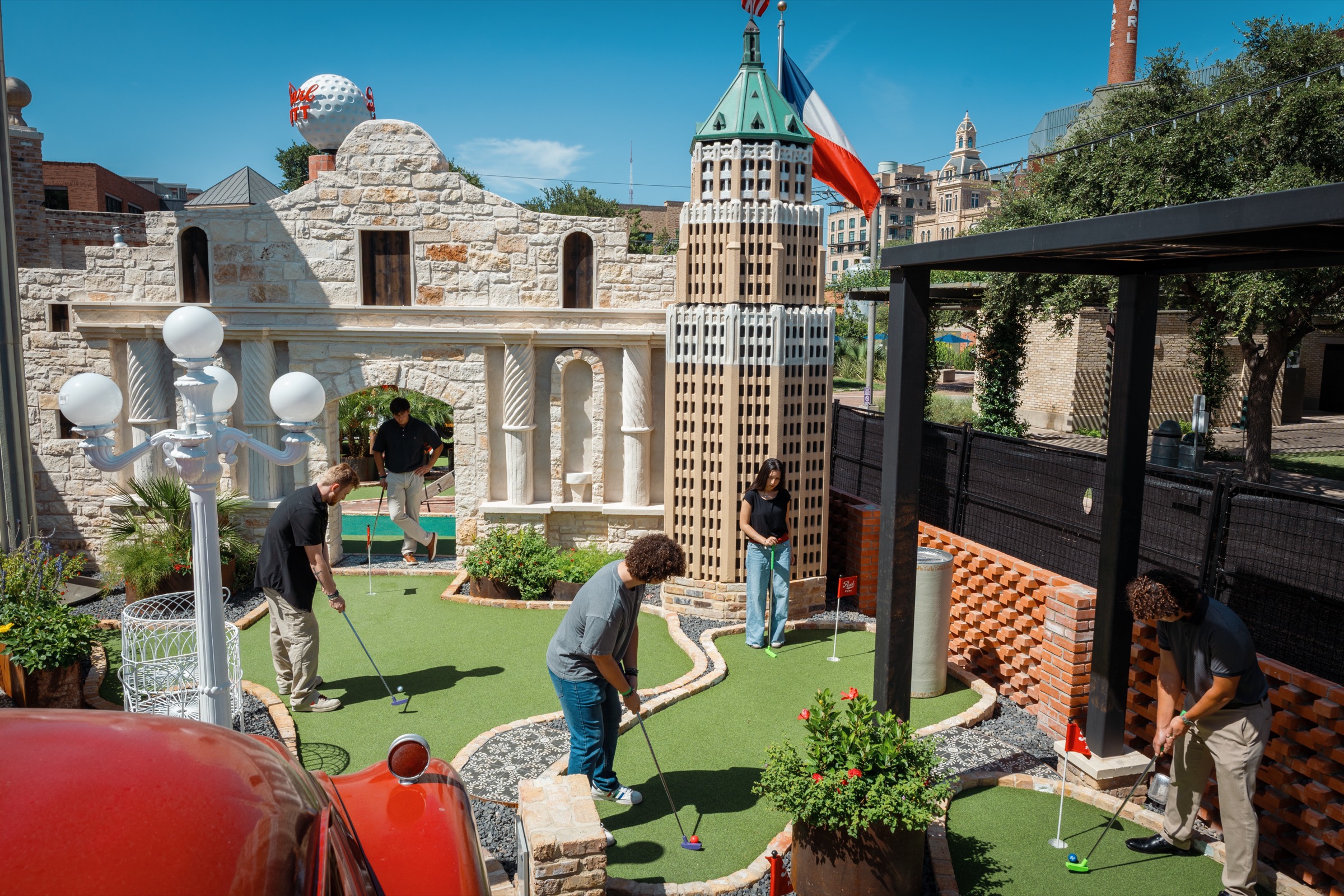 Wide view of the Pearl Putt course with San Antonio landmark replicas and the Tower of the Americas beyond