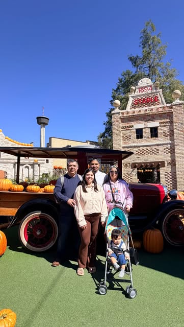 Family with a stroller in front of the Pearl truck and stone facade