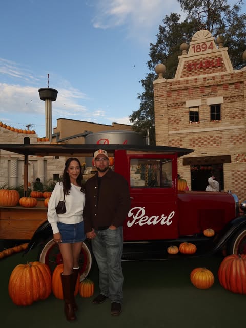 Couple in front of the Pearl truck and stone facade